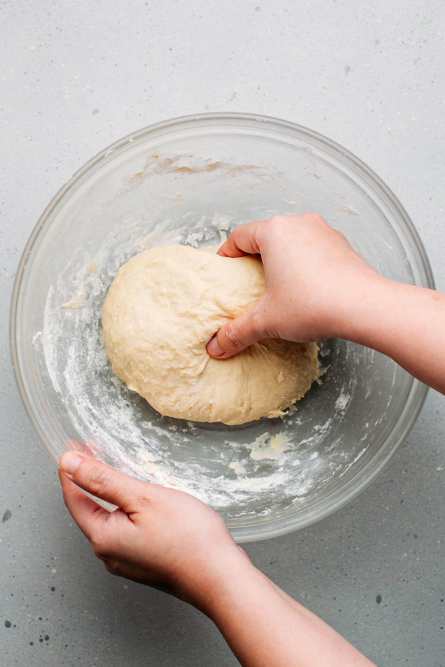Kneading dough in a mixing bowl.