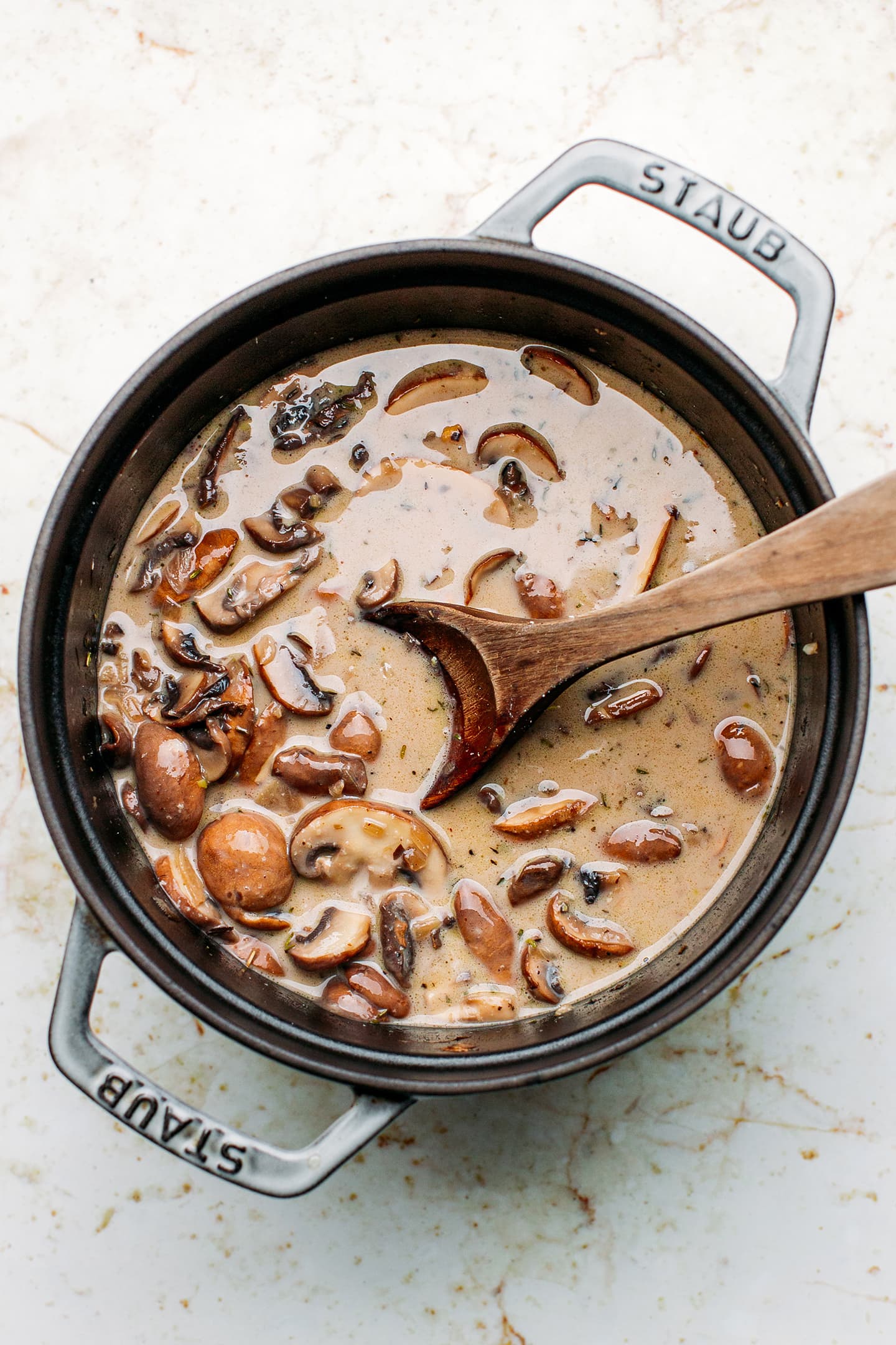 Mushrooms and coconut cream in a pot.