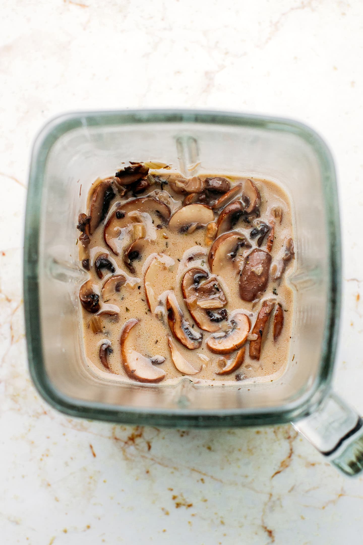 Cooked mushrooms and coconut milk in a blender.