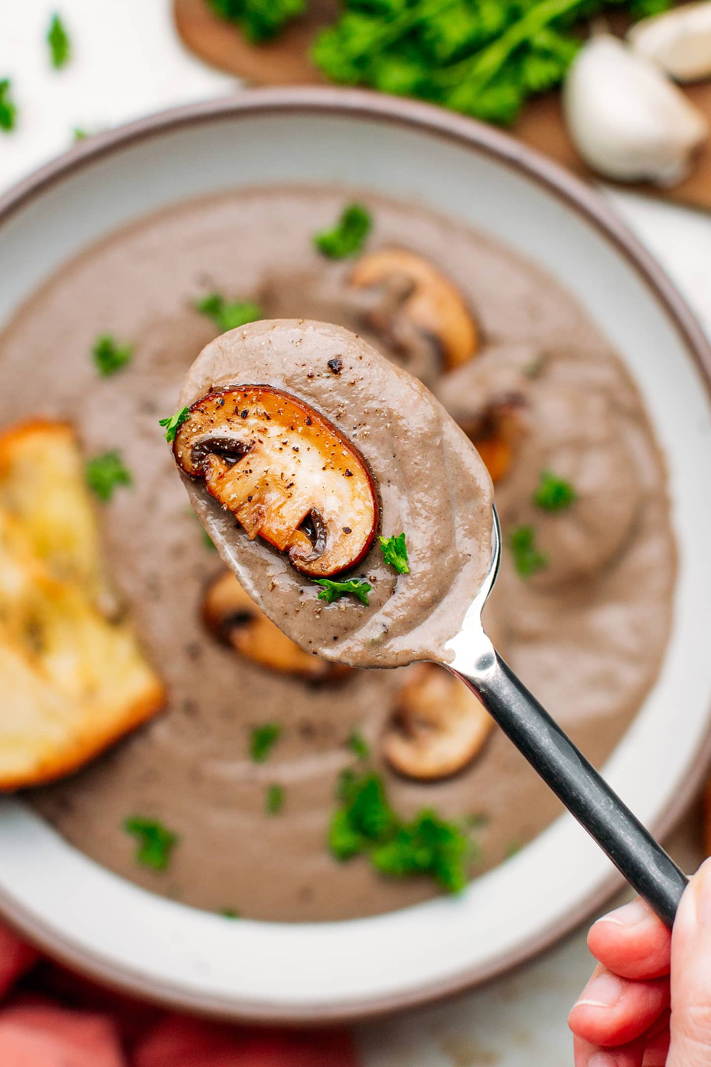 Close-up of a spoonful of mushroom soup.