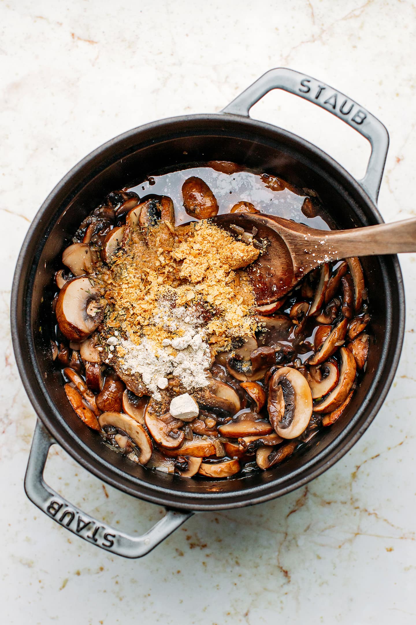Mushrooms and nutritional yeast in a pot.
