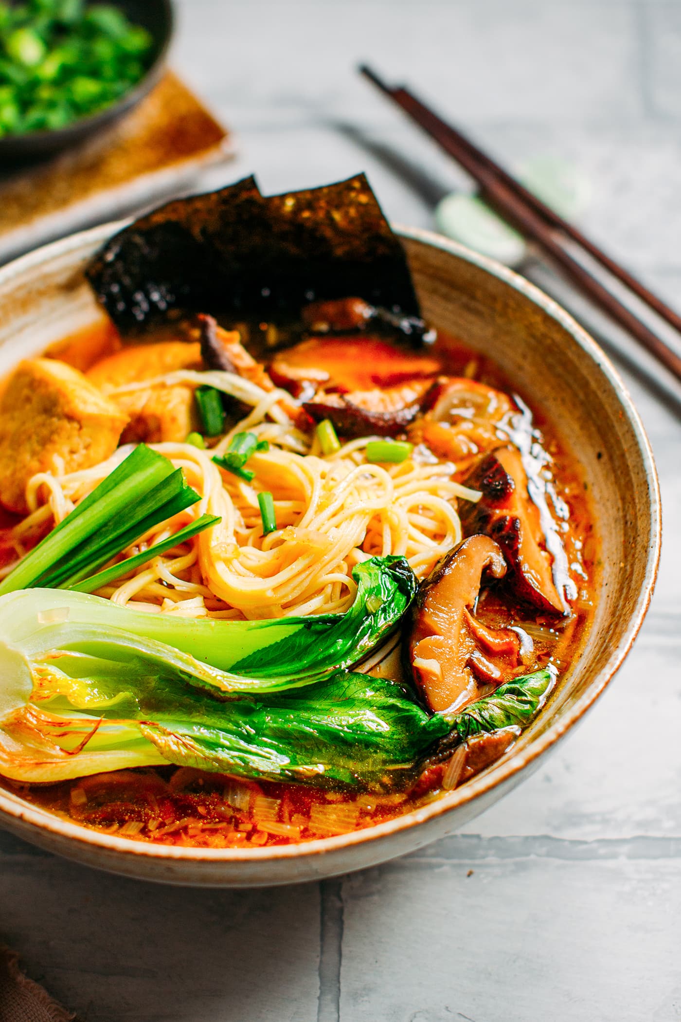 Vegan ramen with noodles, mushrooms, and pak choi