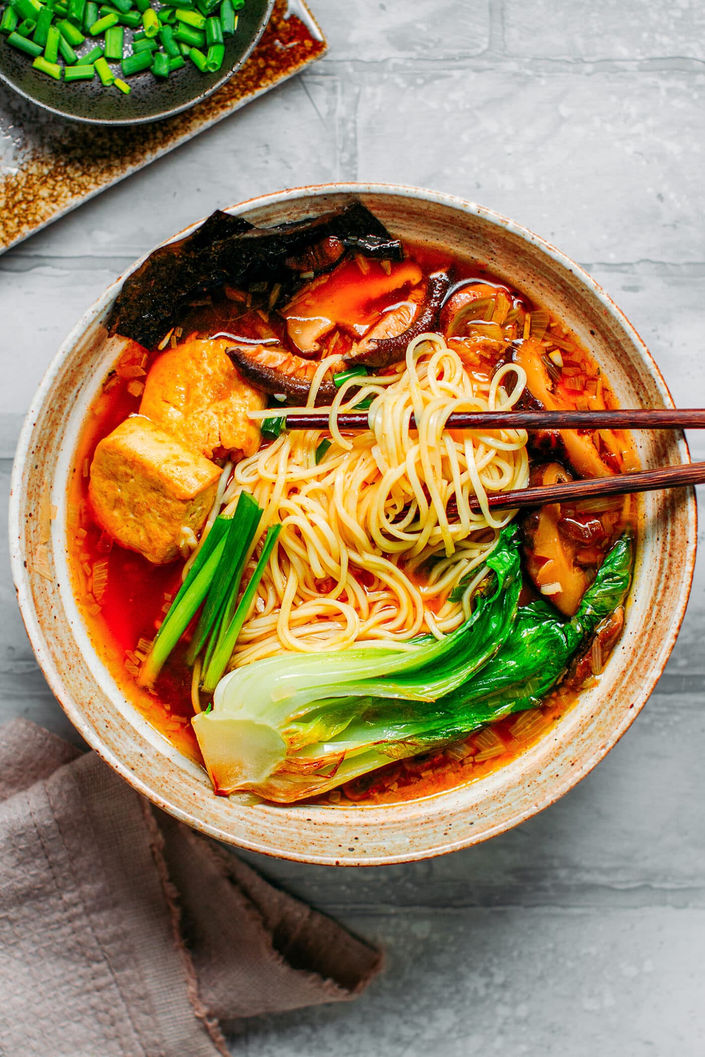 Vegan ramen with noodles, tofu, mushrooms, and pak choi
