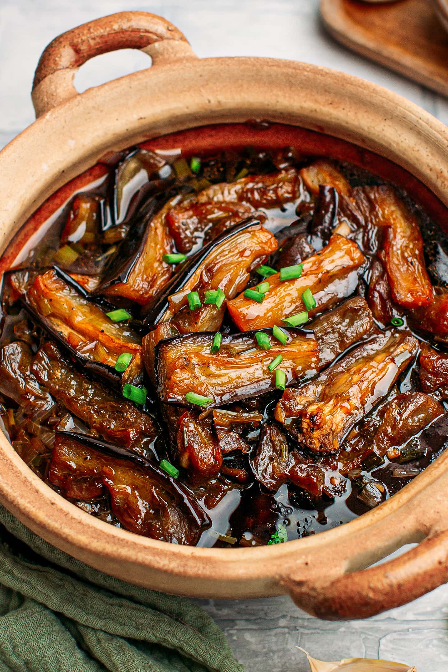 Close-up of eggplant stew with green onions.