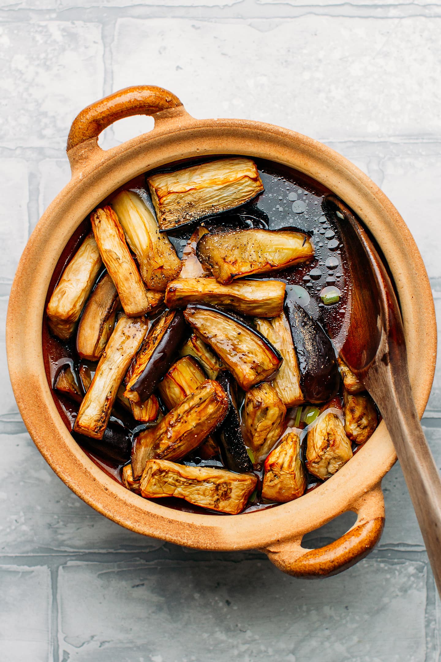 Roasted eggplants in a clay pot.