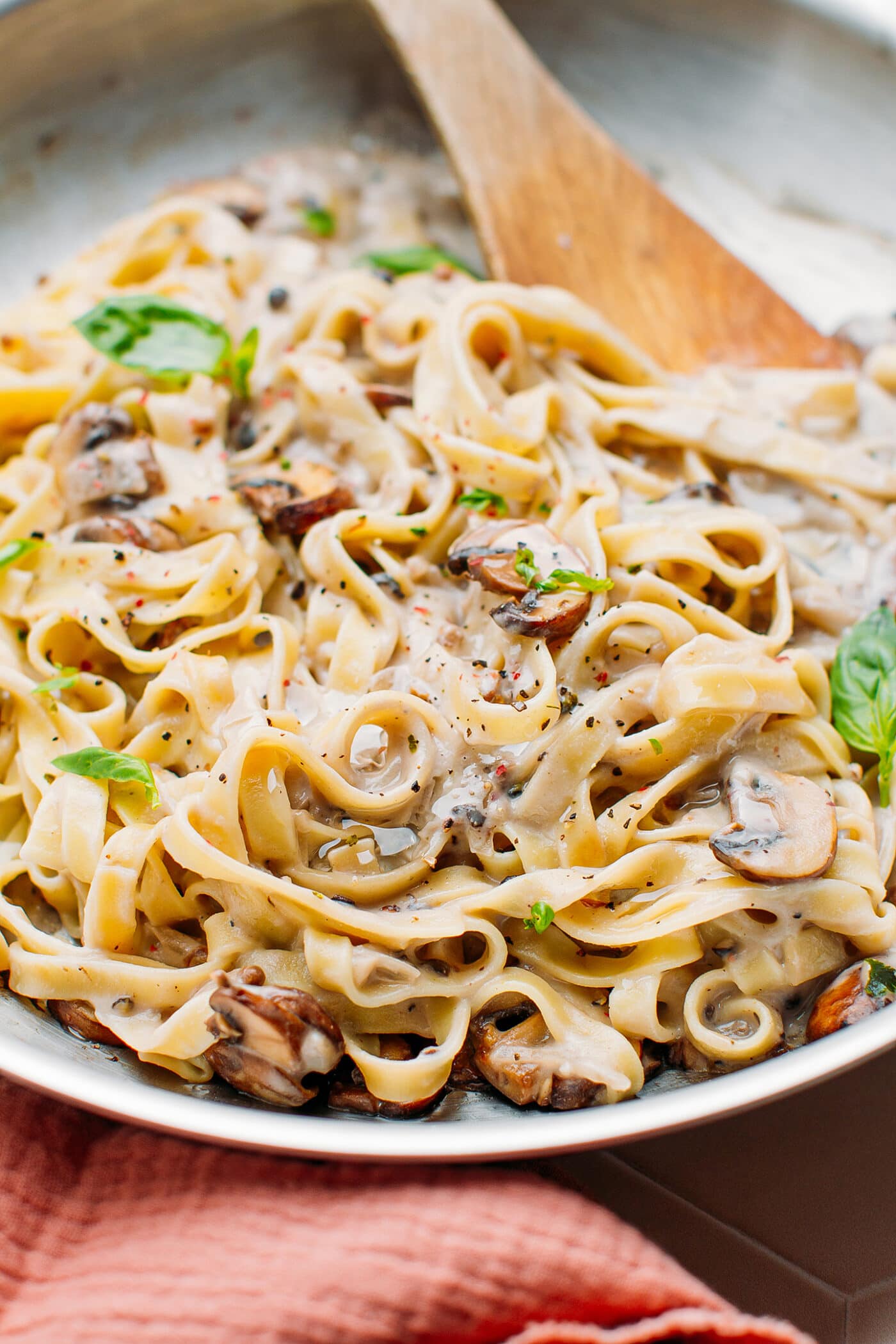Close-up of pasta with peppercorn sauce and mushrooms.