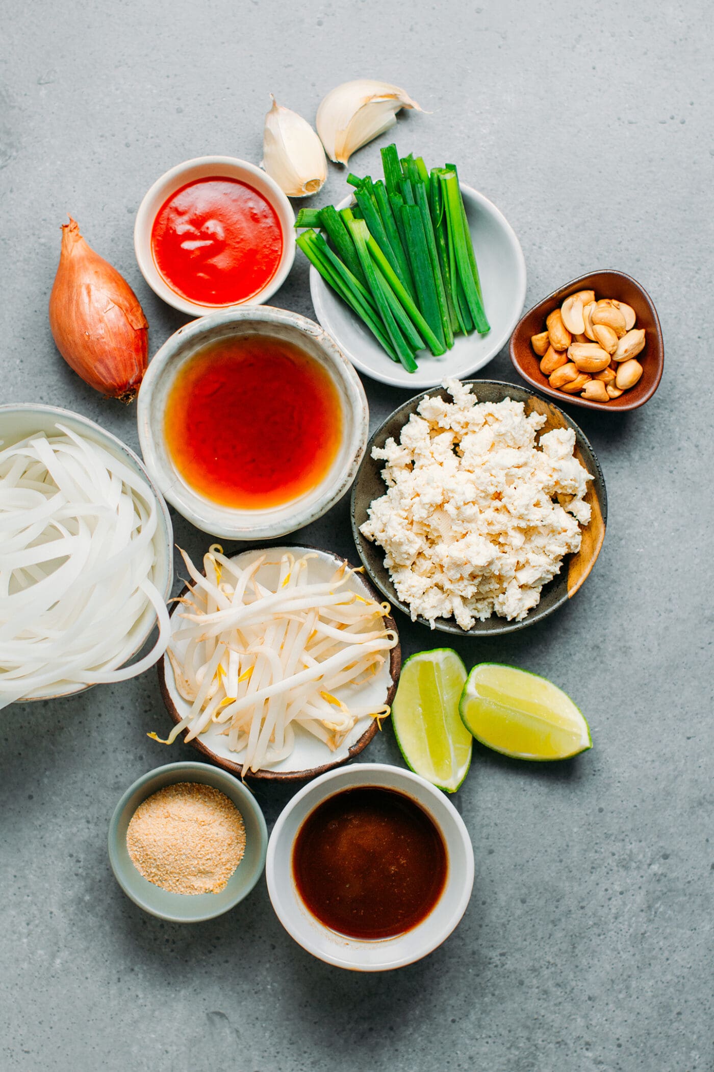 Ingredients like rice noodles, fish sauce, chives, tofu, tamarind juice.