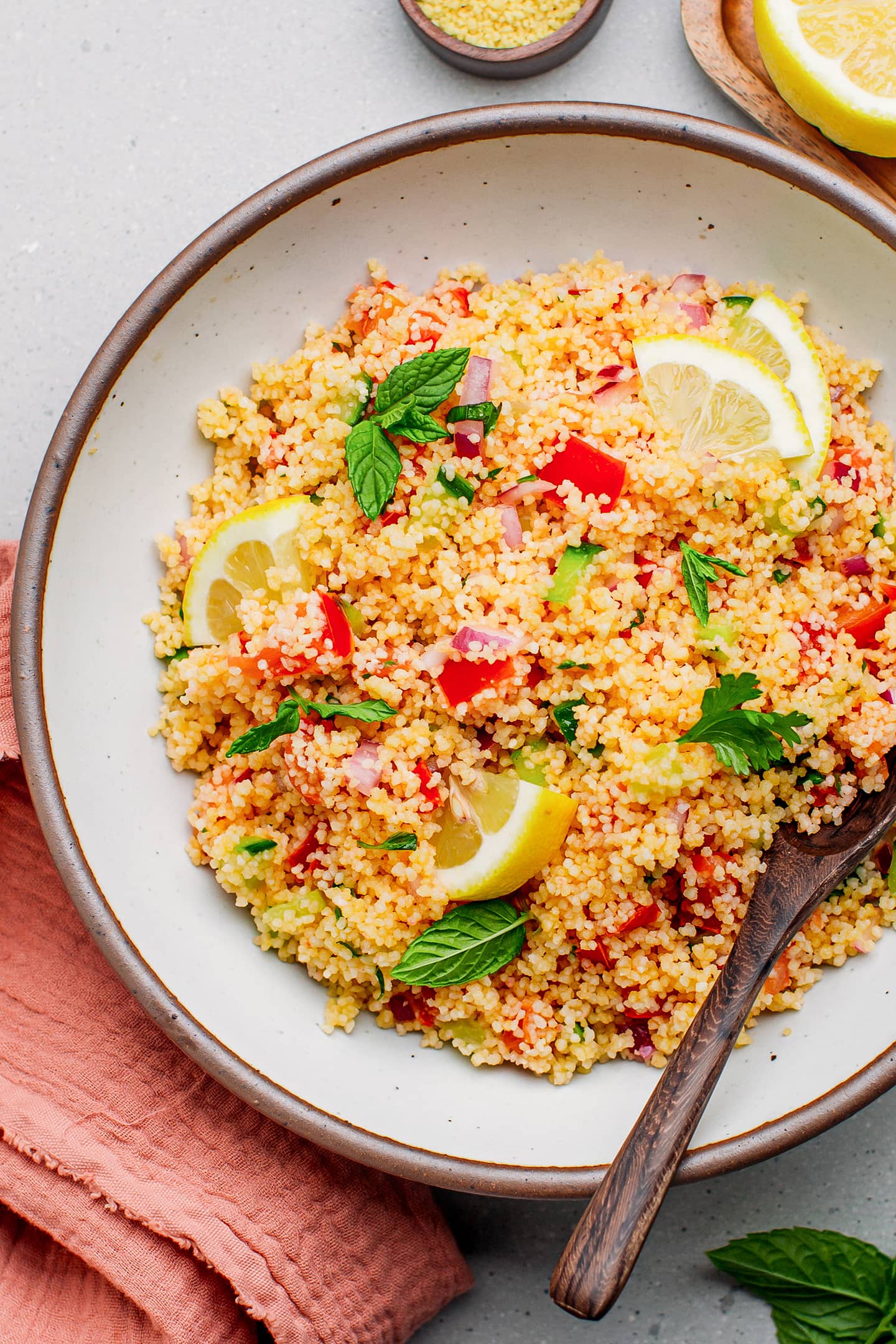 Couscous salad with fresh herbs in a bowl.