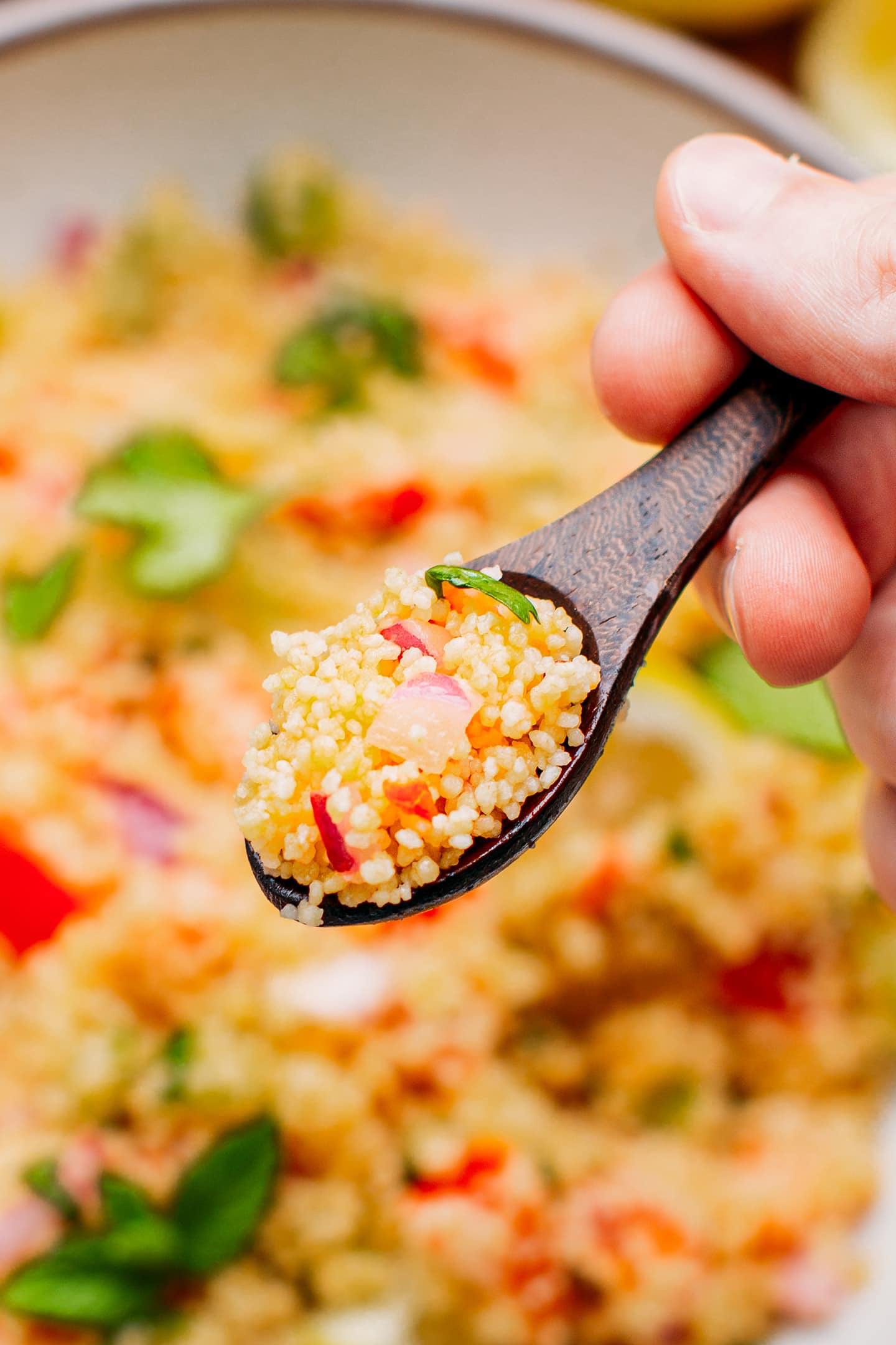Close-up of a spoonful of couscous salad.