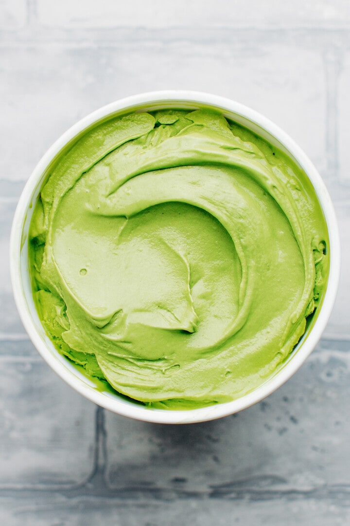 Matcha ice cream in a small container.
