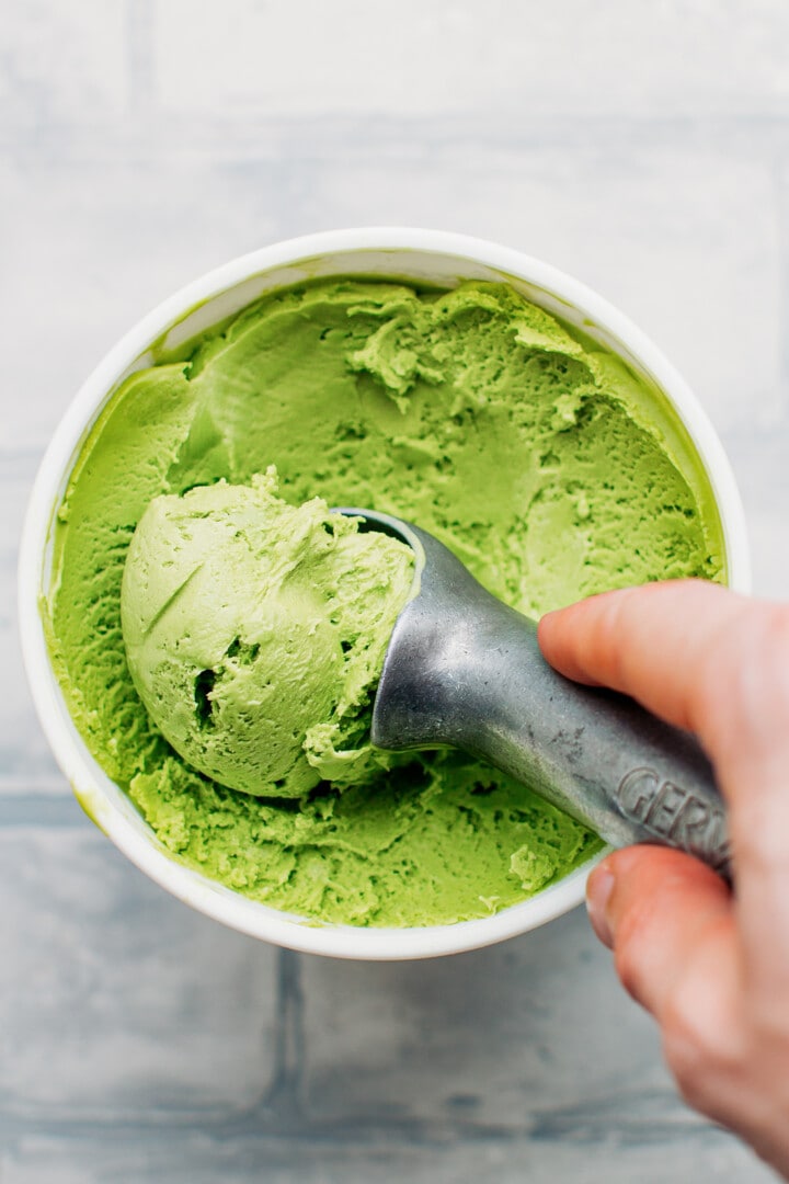 Scooping matcha ice cream using a scoop.