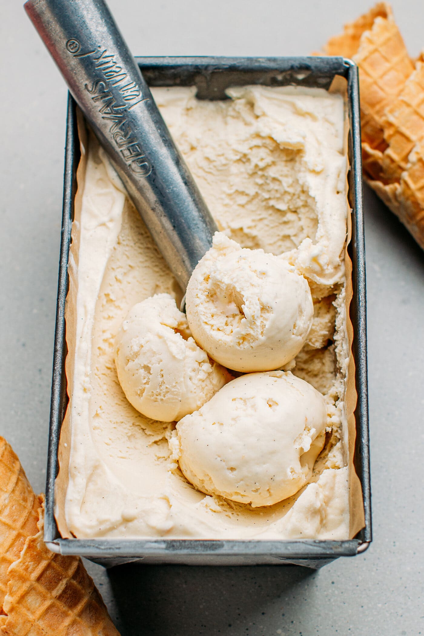 Vanilla ice cream scoops in a container.