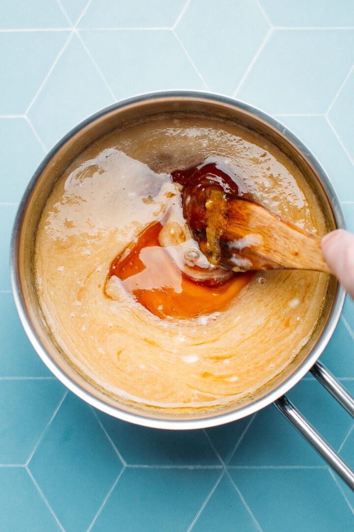 Stirring salted caramel in a saucepan.