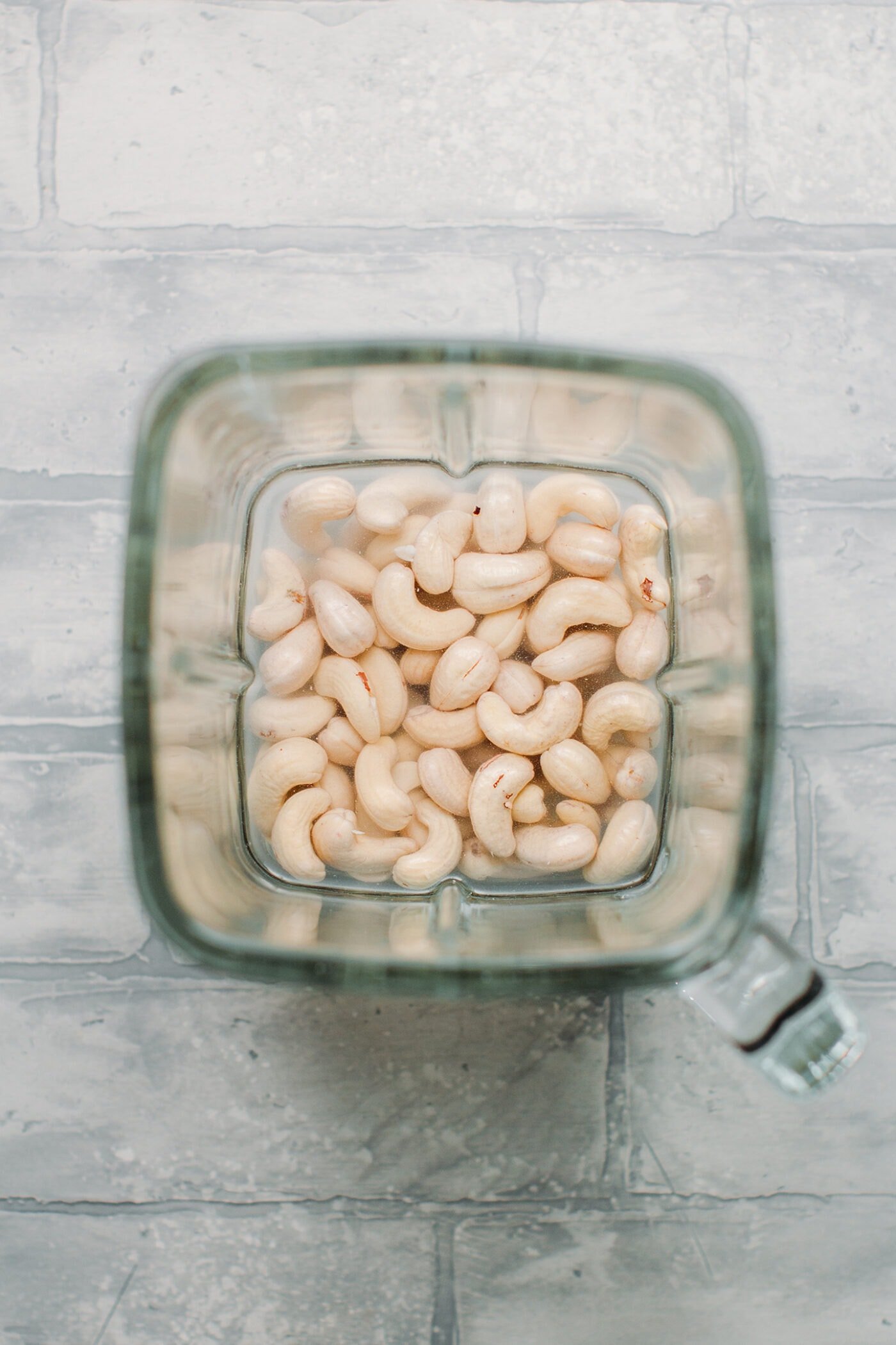 Raw cashews in a blender.