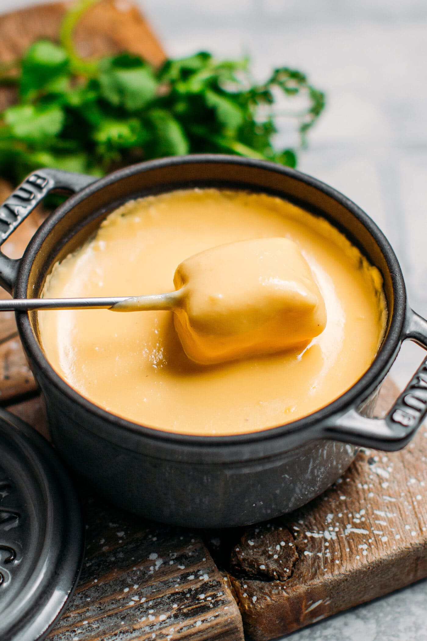 Dipping bread into vegan fondue.