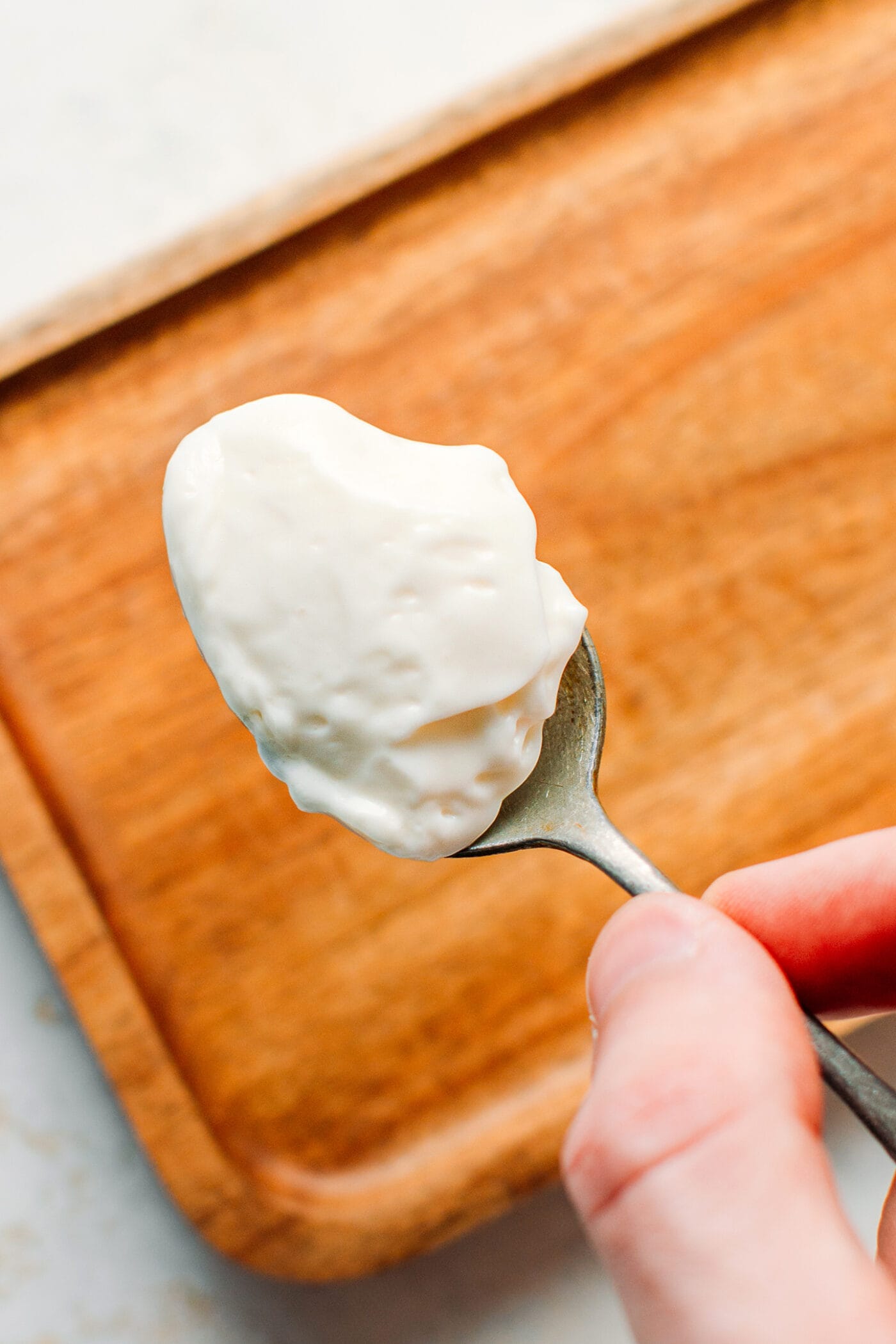Close up of a spoonful of vegan mayo.