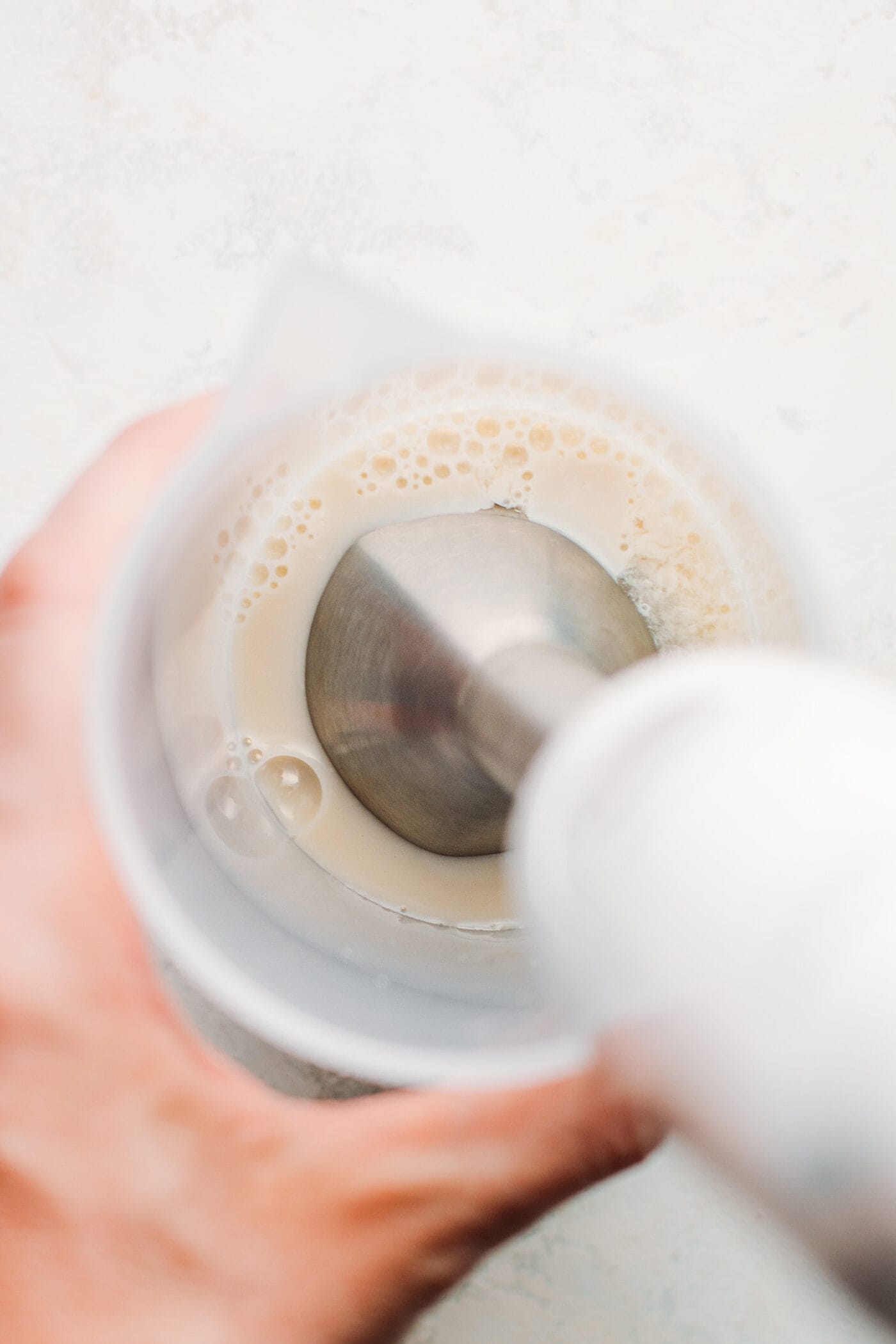 Blending soy milk with an immersion blender.