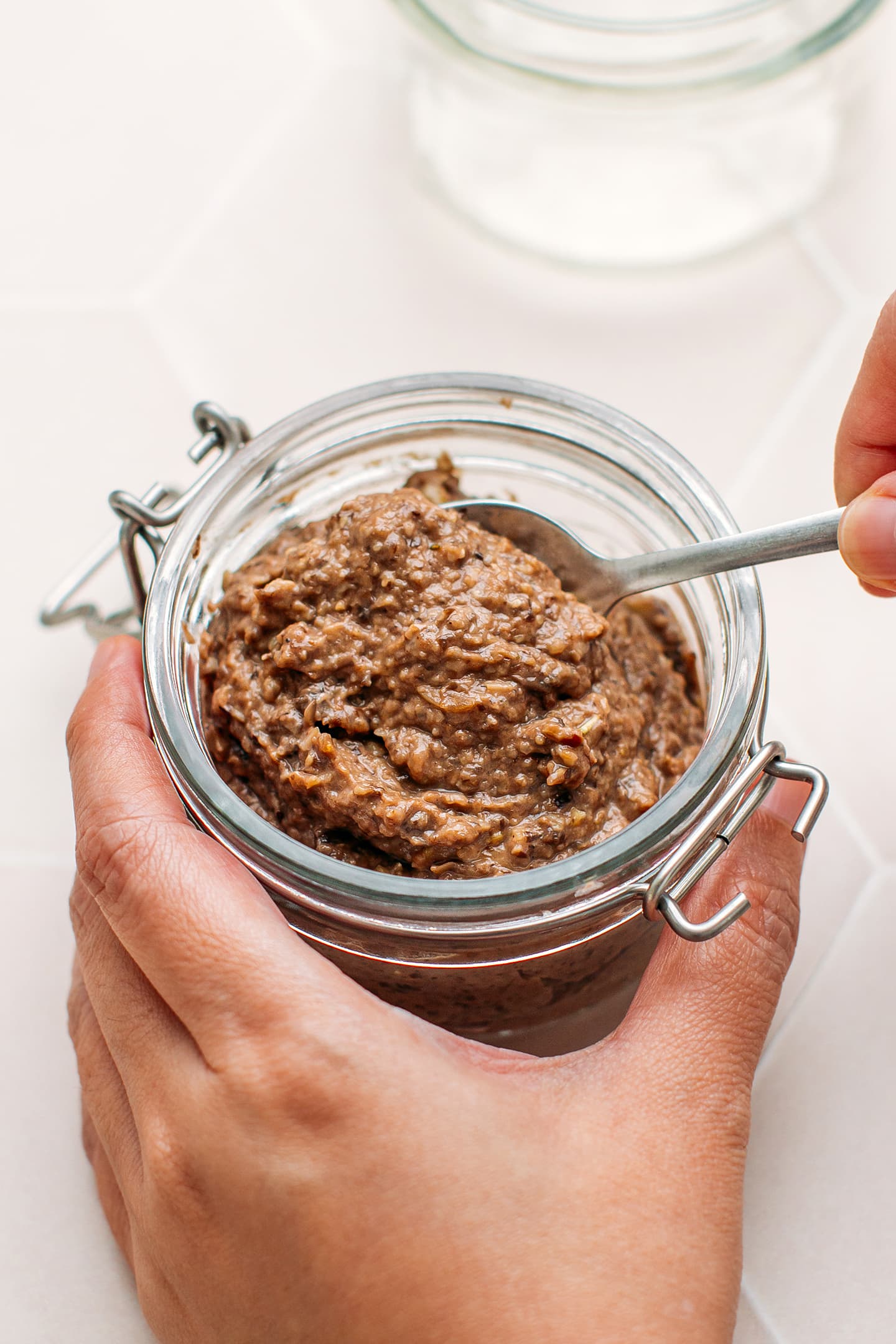 Pouring vegan paté in a jar.