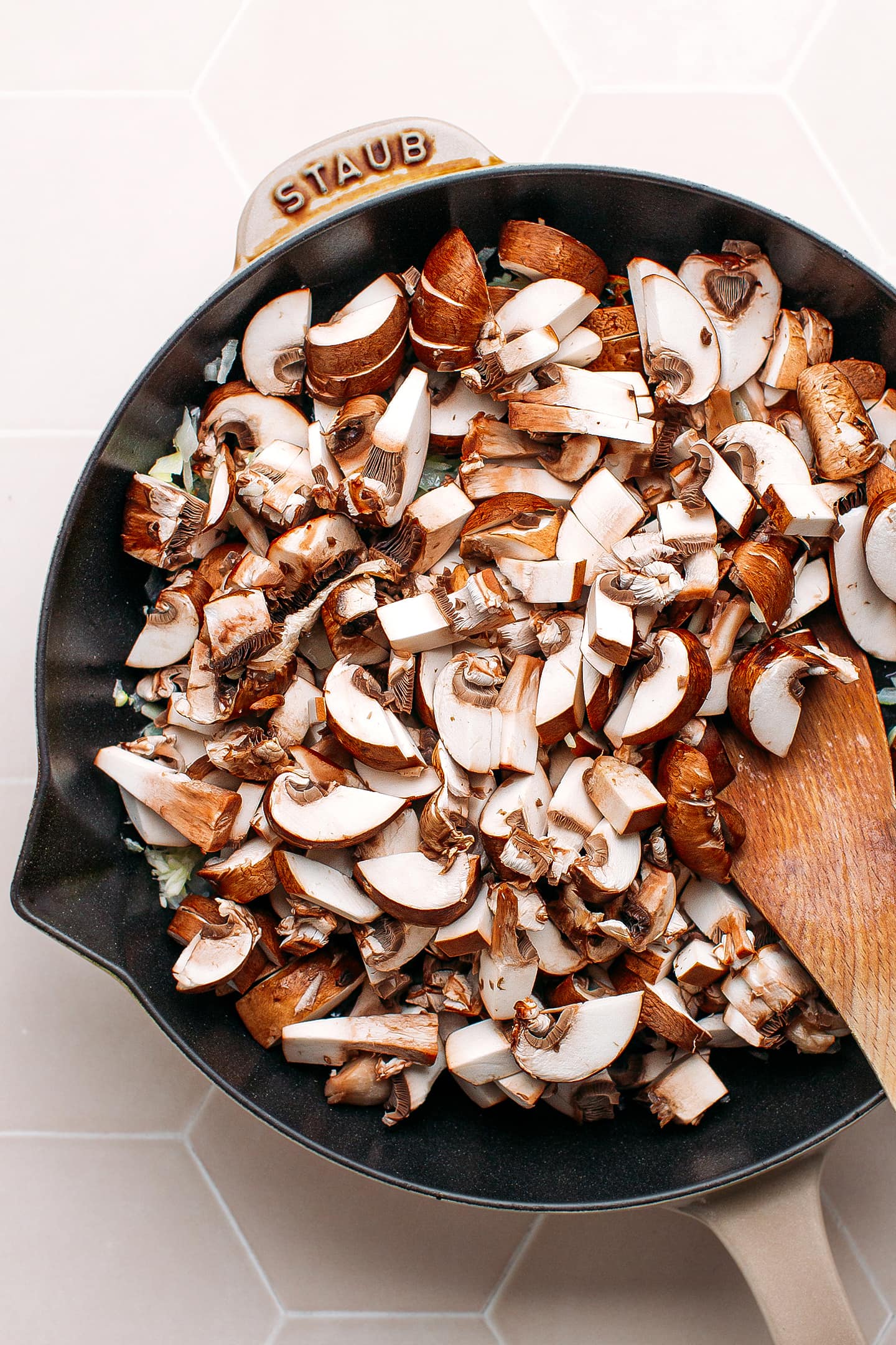 Diced mushrooms in a skillet.