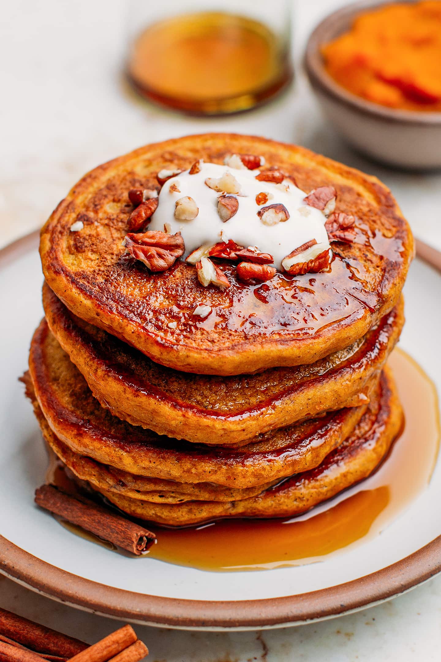 Pumpkin pancakes topped with yogurt and crushed pecans.