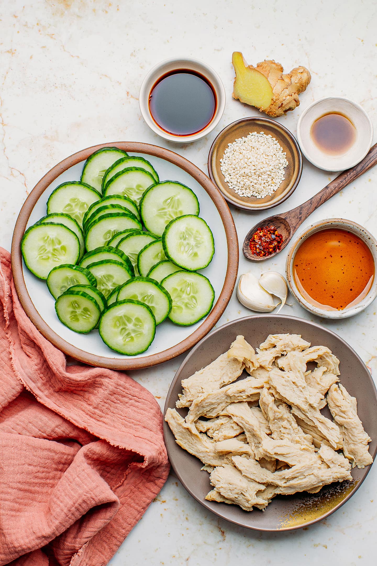 Ingredients like sliced cucumber, vegan chicken, garlic, soy sauce, and ginger.