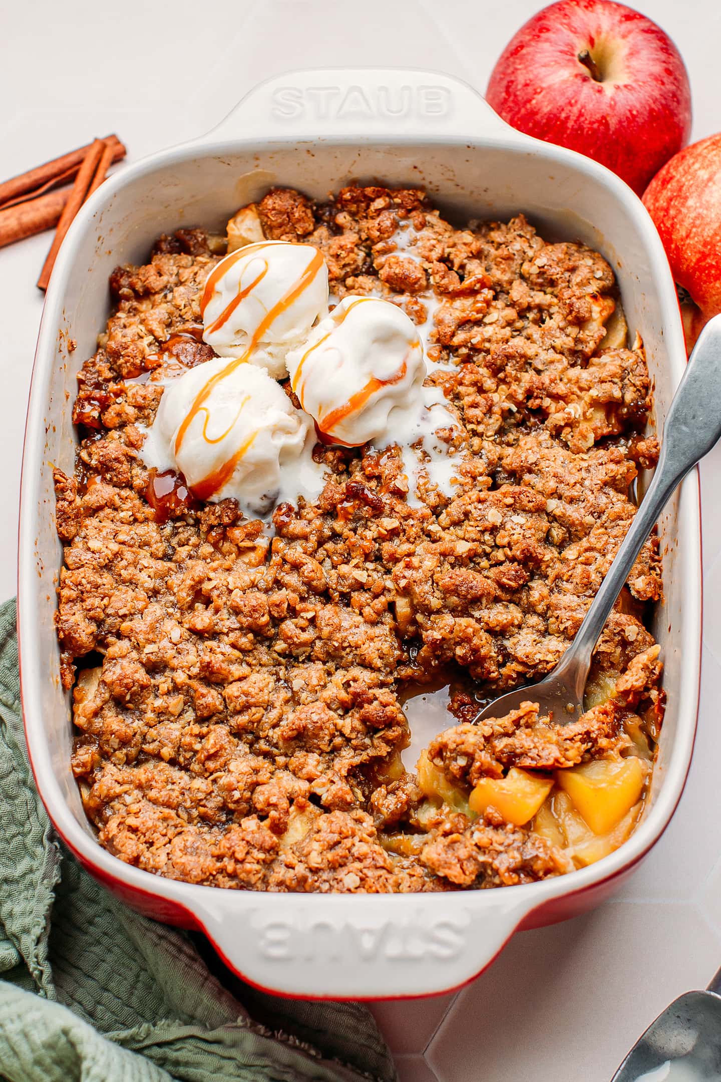 Apple crisp topped with vanilla ice cream and caramel.