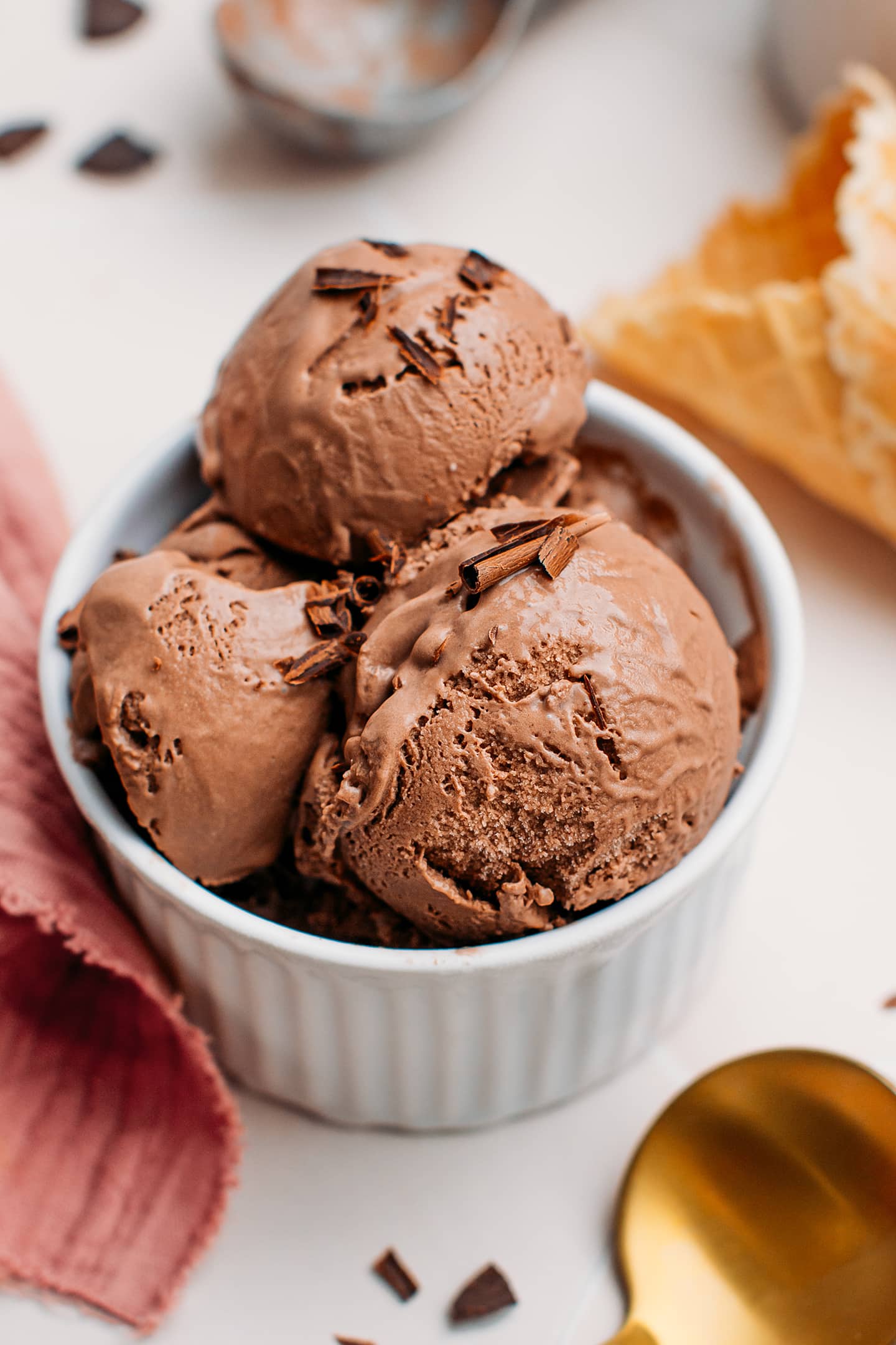Scoops of vegan chocolate ice cream in a ramekin.