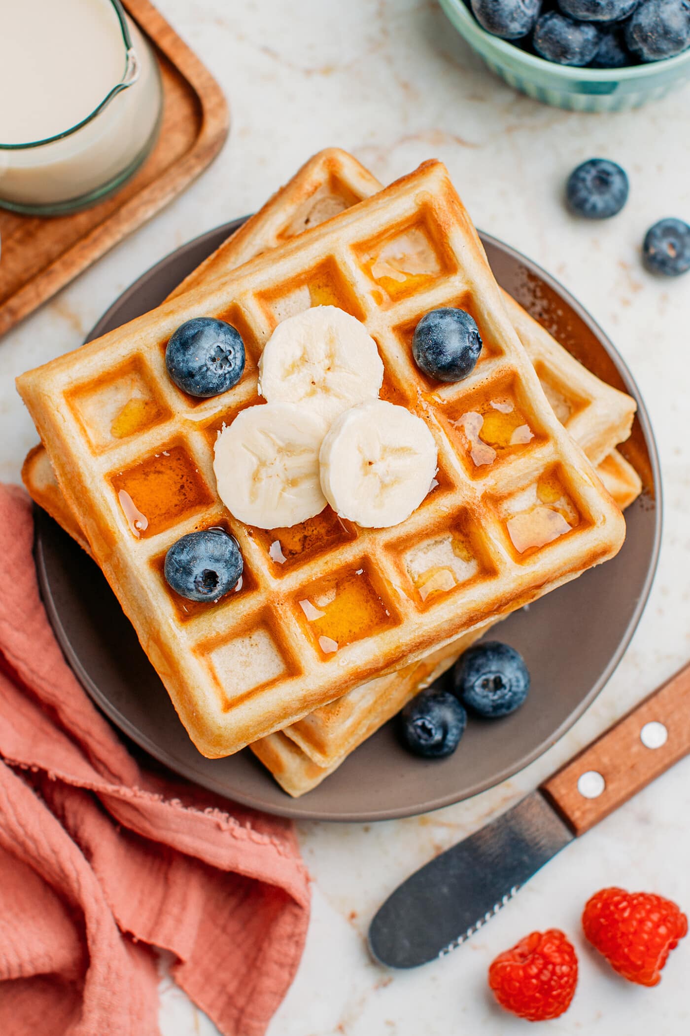 Top view of waffles with bananas and blueberries.