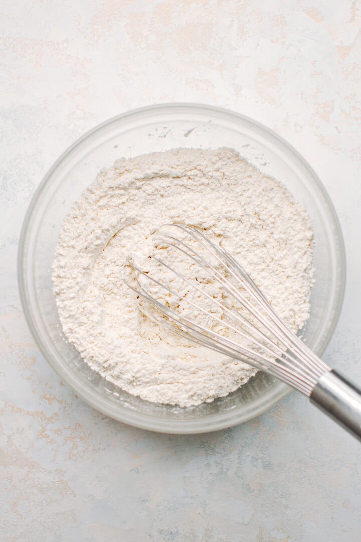 Whisking flour in a bowl.