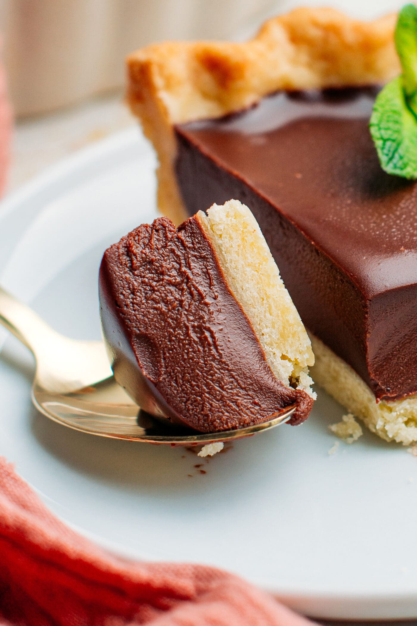 Close-up of a spoonful of chocolate tart.