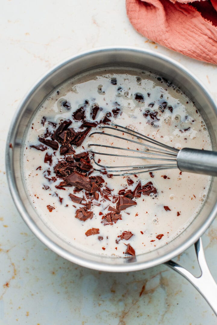 Dark chocolate chunks with milk in a saucepan.