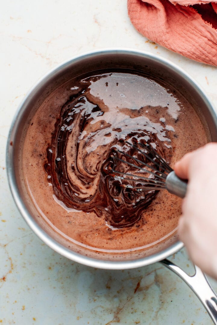 Chocolate ganache in a saucepan.