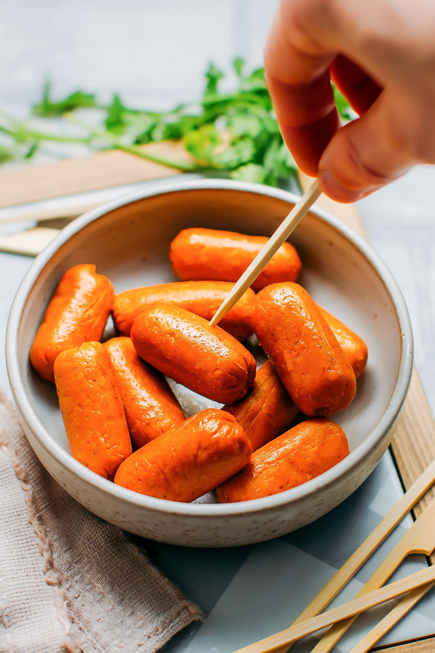 Vegan Sausages in a bowl with a skewer