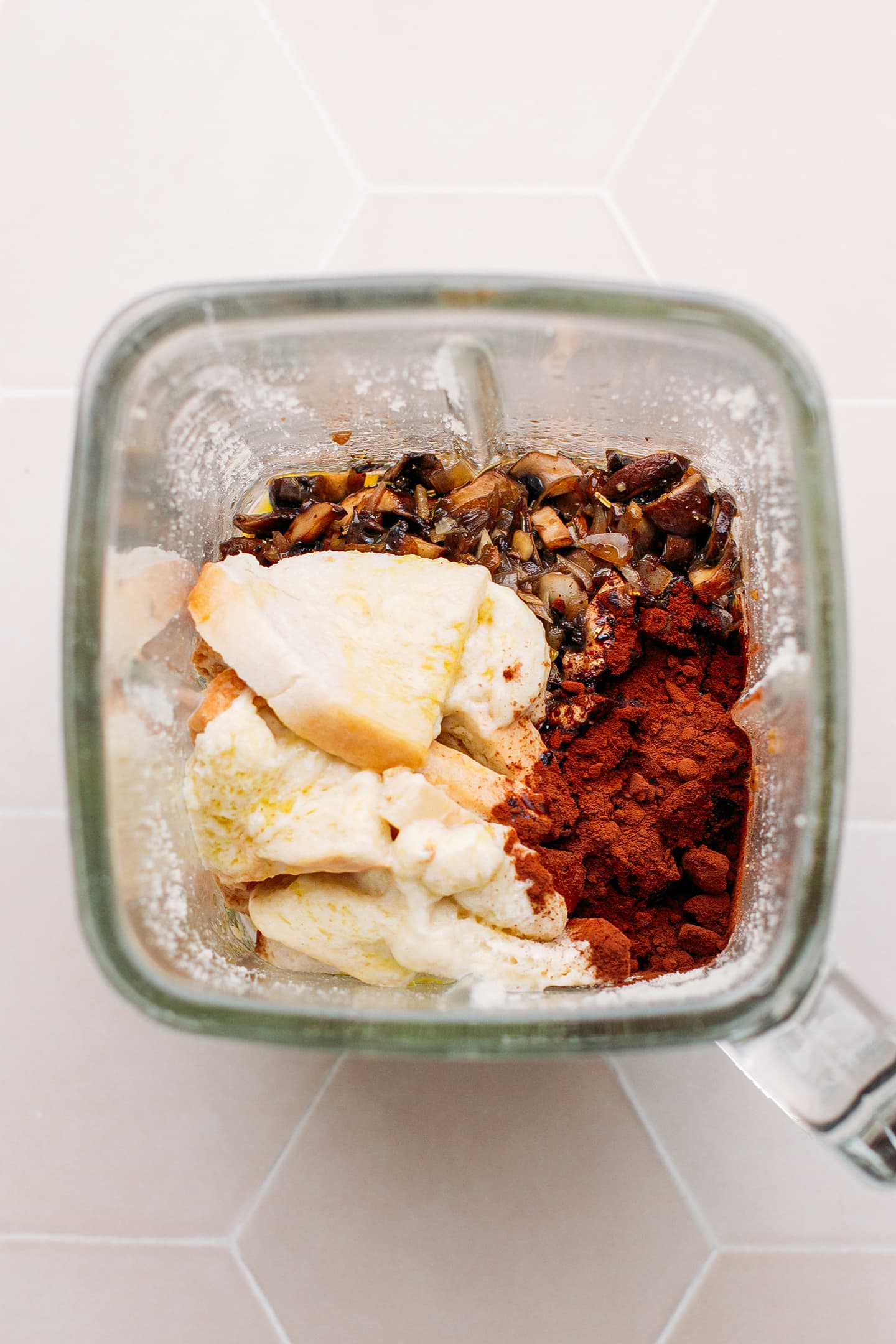 Mushrooms, bread, and cacao powder in a blender.