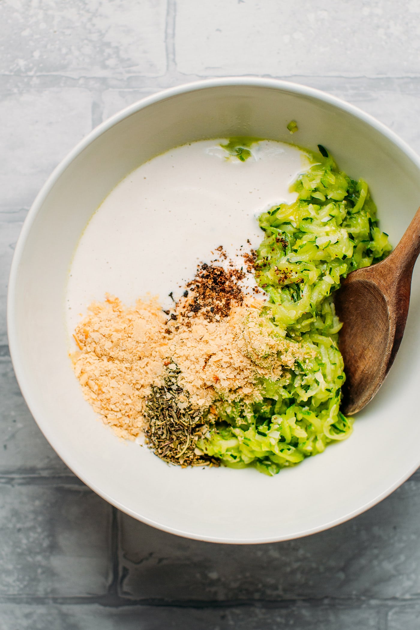 Zucchini, nutritional yeast, and cashew cream in a bowl.