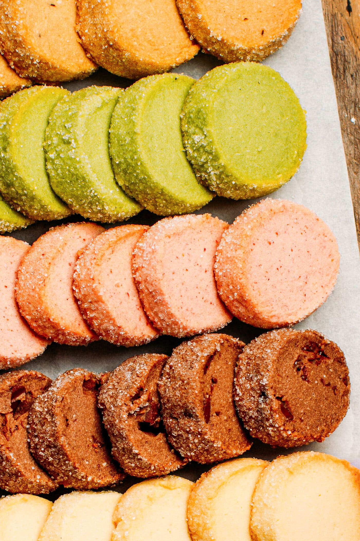 Close up of matcha, chocolate, strawberry, and vanilla shortbread cookies.