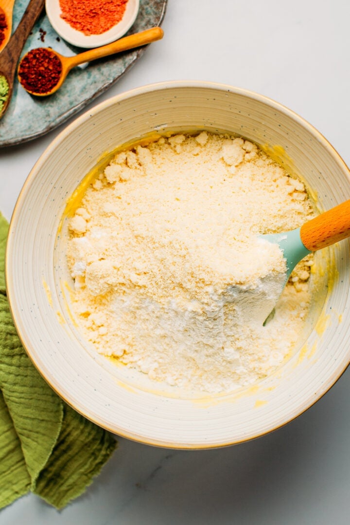 Butter, sugar, flour, and almond flour in a bowl.