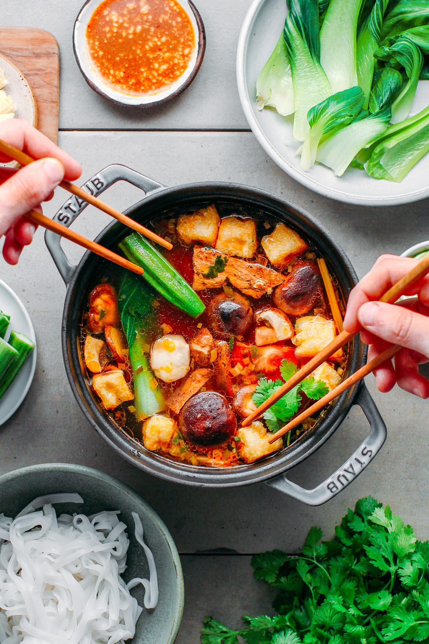 Vegan hot pot with mushrooms, tofu, and pak choi.